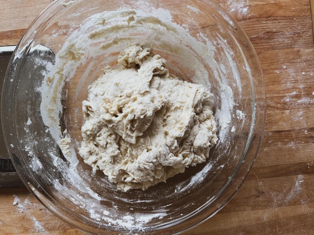mixed dough in a glass bowl