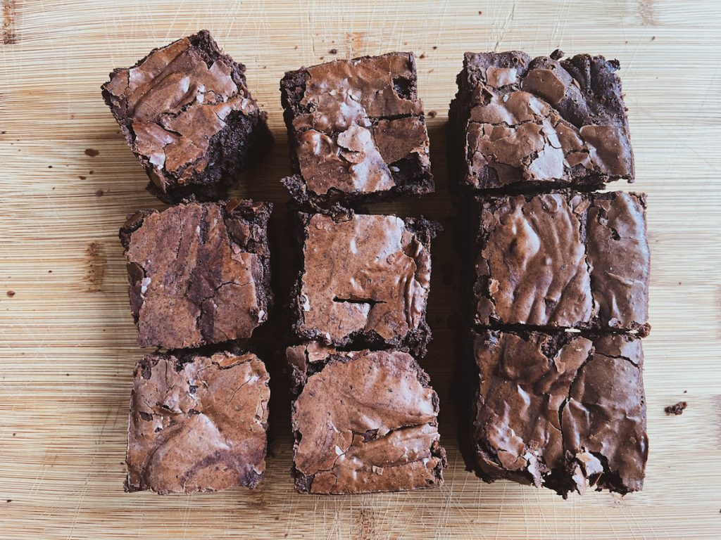 six brownies on a wooden board