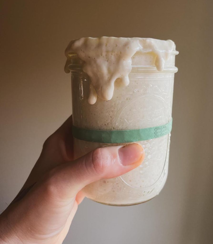 sourdough starter in jar spilling over