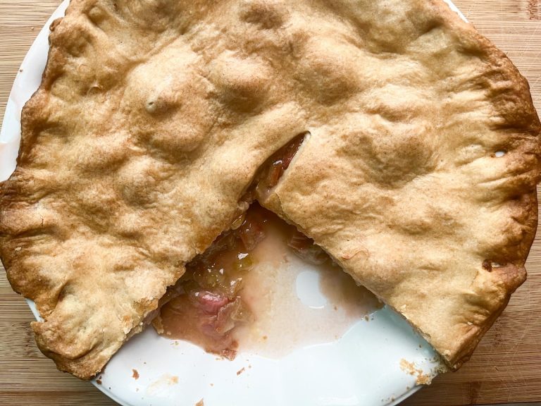 freshly baked rhubarb pie with a slice missing